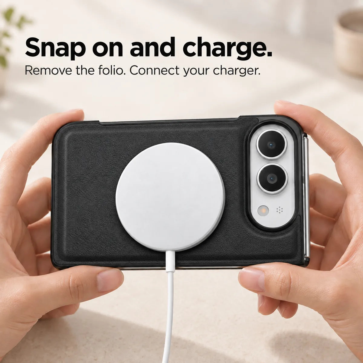 Midnight Black phone case held horizontally with a magnetic charging puck attached to the rear. #color_Midnight Black