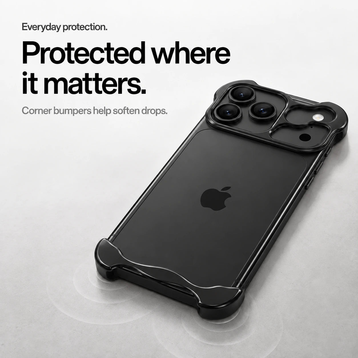 Black sculpted metal phone case on a desk showing its protective corner bumpers #color_Midnight Black