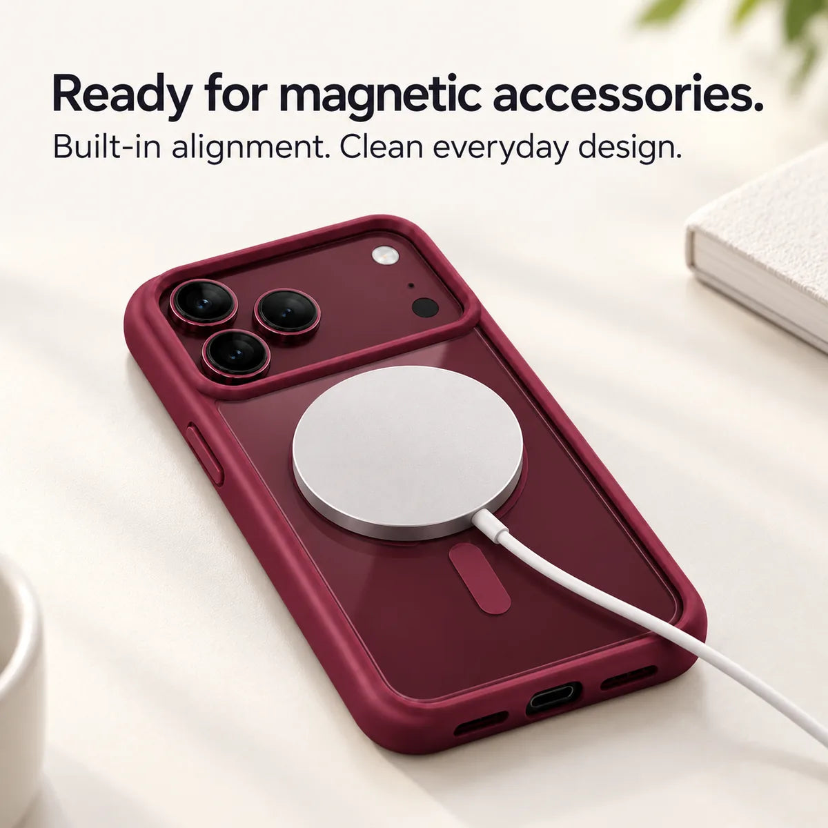 Burgundy clear back phone case with a round magnetic charging puck attached. #color_Burgundy