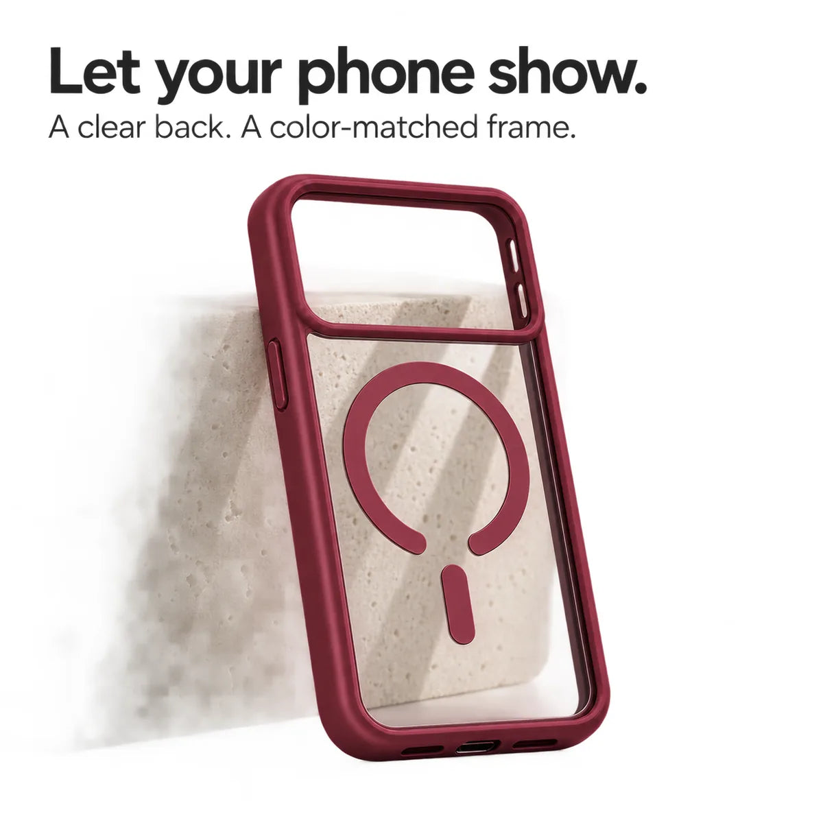 Burgundy empty phone case showing its transparent back and magnetic ring against a pale stone block. #color_Burgundy