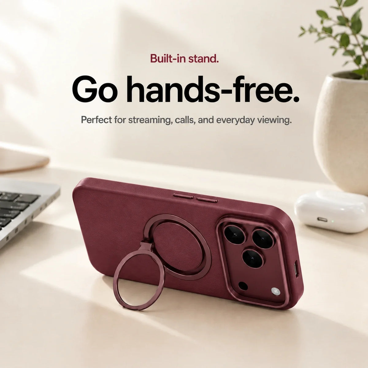 Burgundy leather-finish phone case propped horizontally on its ring stand on a desk #color_Burgundy