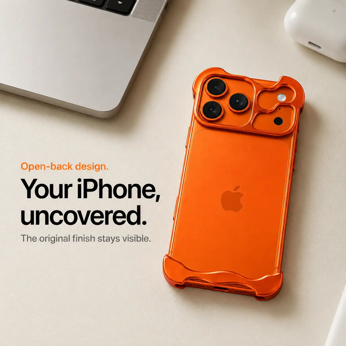 Orange open-back phone case resting beside a laptop #color_Cosmic Orange