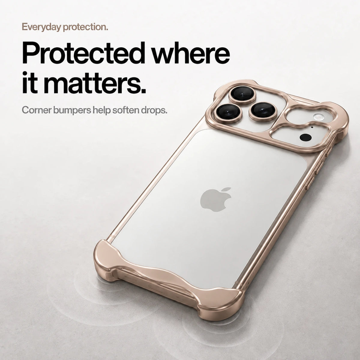 Champagne gold sculpted metal phone case on a desk showing its protective corner bumpers #color_Champagne Gold