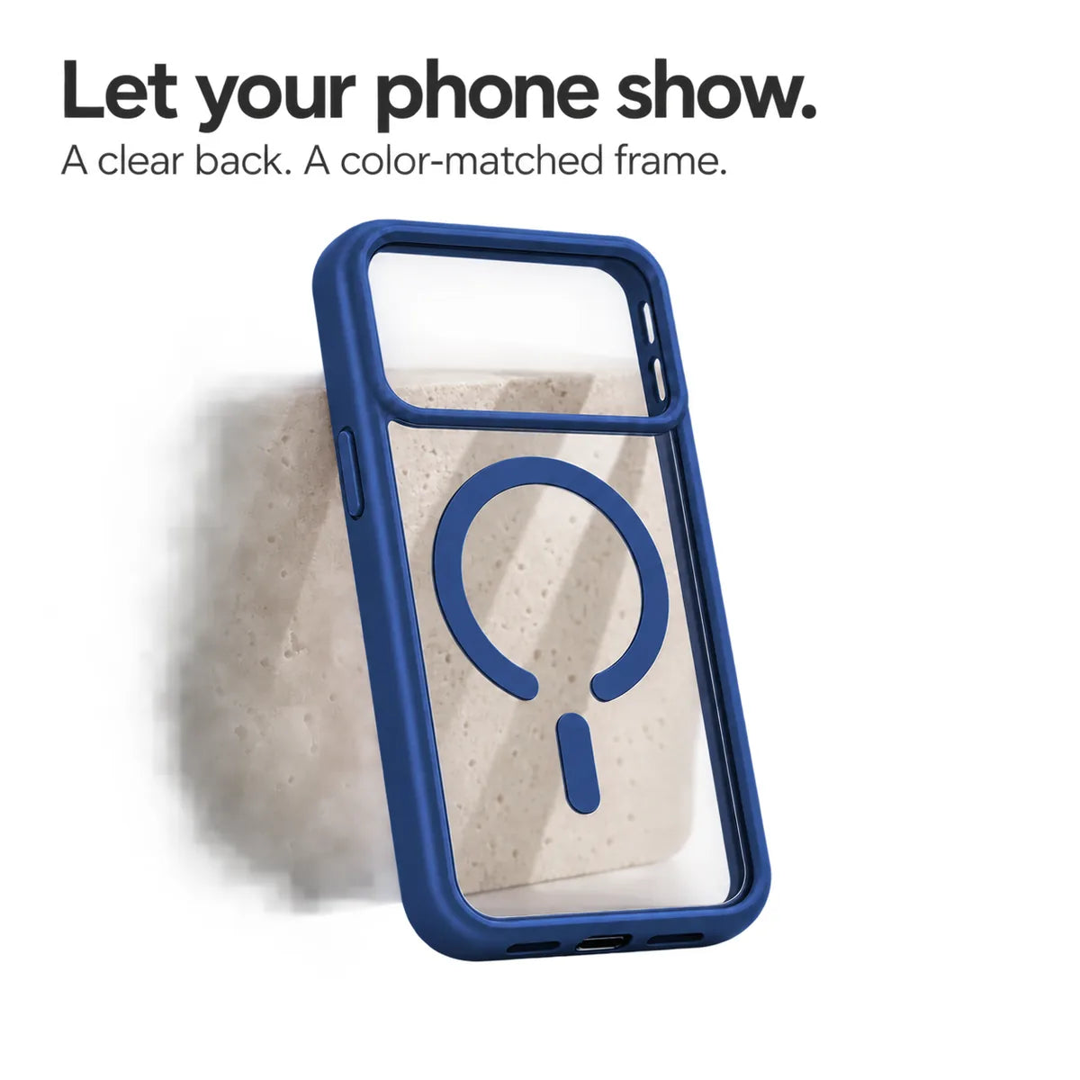 Dark blue empty phone case showing its transparent back and magnetic ring against a pale stone block. #color_Deep Blue