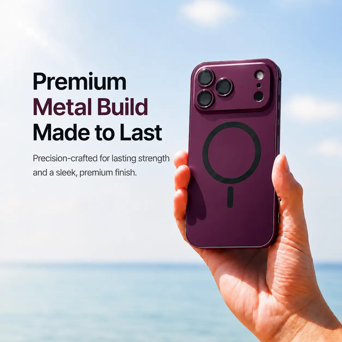 Burgundy metal magnetic phone case held upright beside the sea with a material feature caption #color_Burgundy