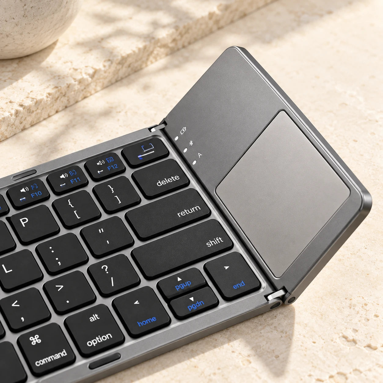 Close-up of the rectangular trackpad on a gray folding keyboard.