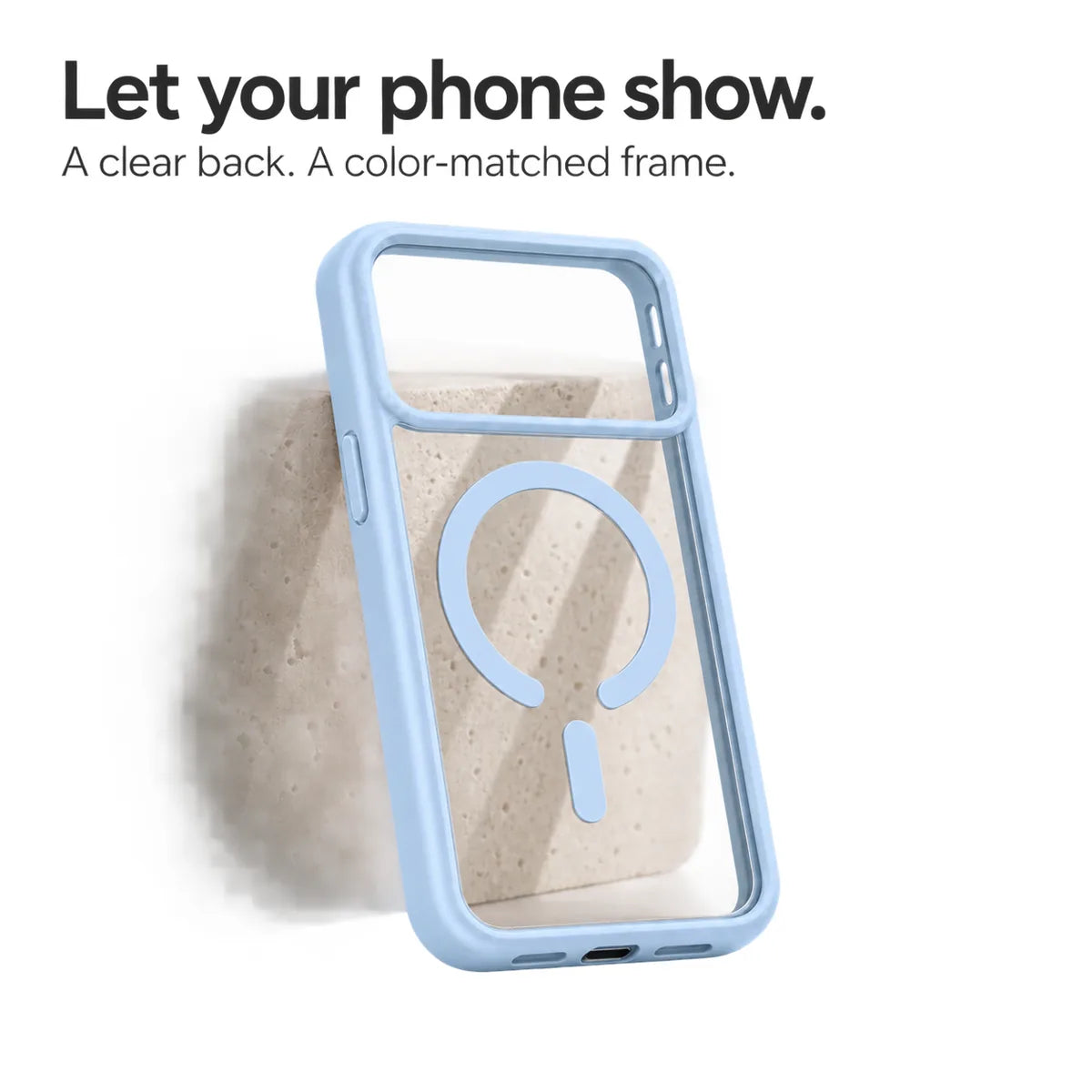 Light blue empty phone case showing its transparent back and magnetic ring against a pale stone block. #color_Glacier