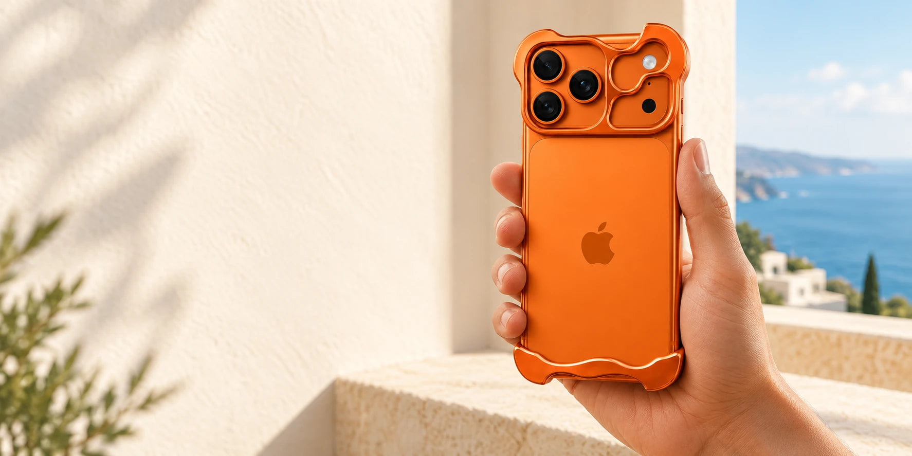 Hand holding an orange phone in a sculpted metal bumper case with an open back.