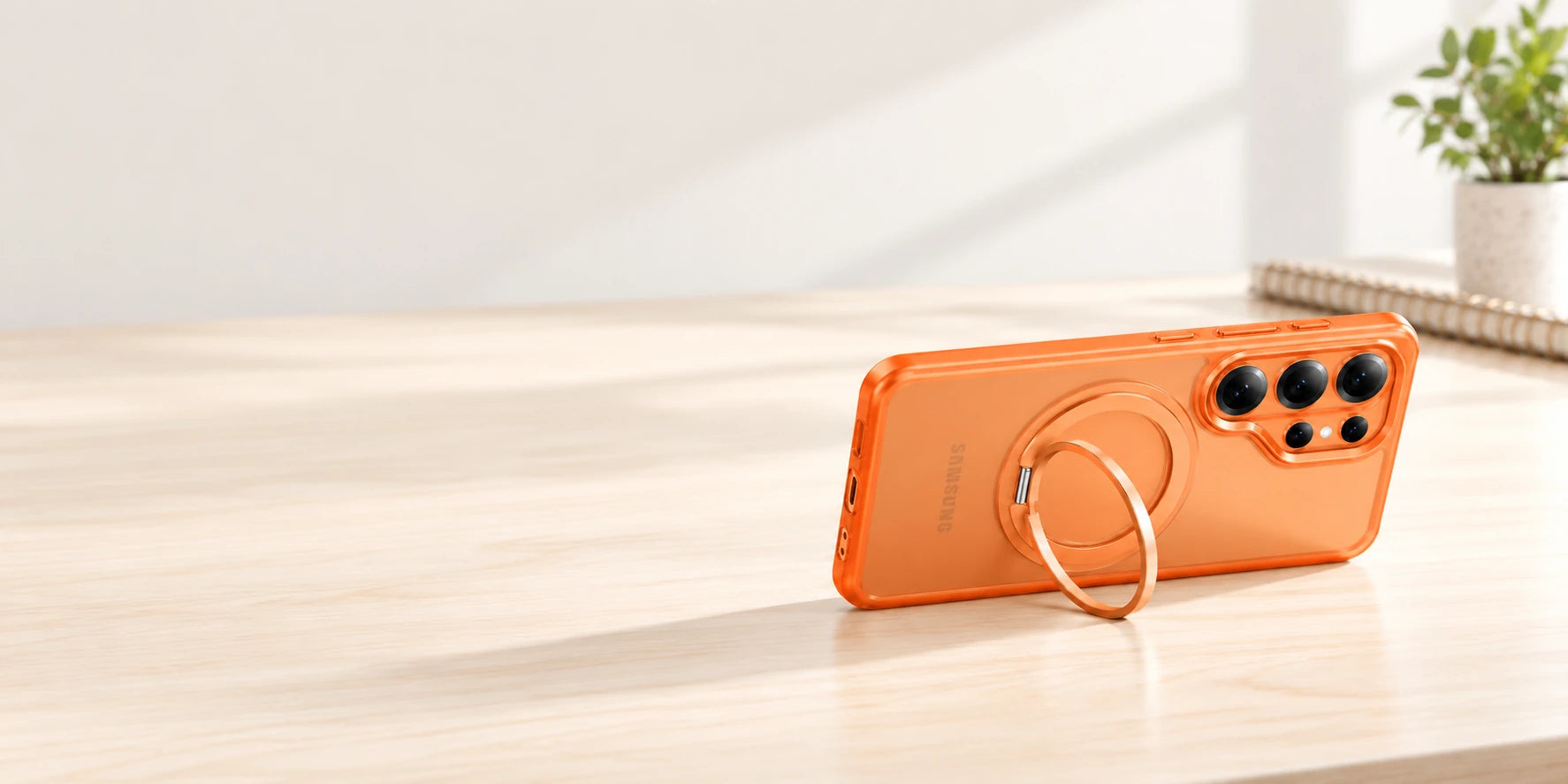 Phone case resting in landscape with its original ring supporting it from the side.