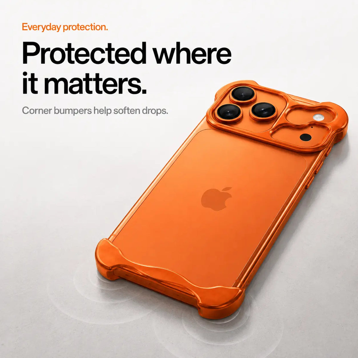 Orange sculpted phone case lying on a desk to show raised corner protection #color_Cosmic Orange
