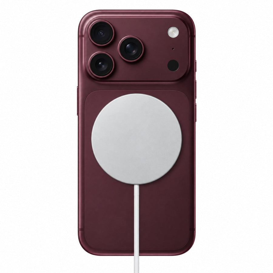 Qi2 25W magnetic wireless charger attached to a Burgundy iPhone.