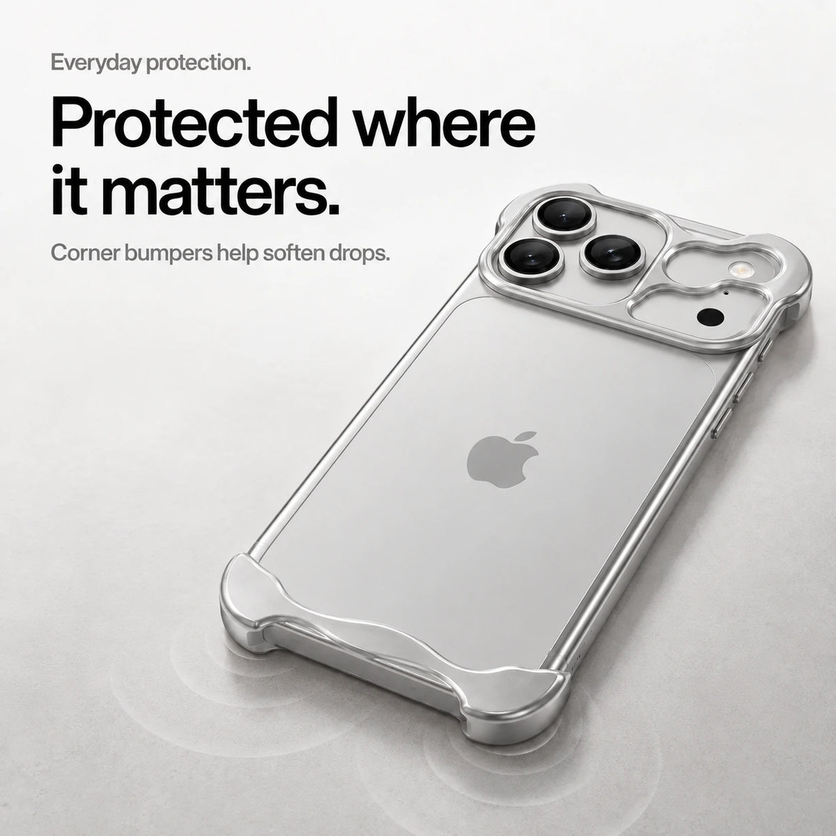 Silver sculpted metal phone case on a desk showing its protective corner bumpers #color_Titanium Silver