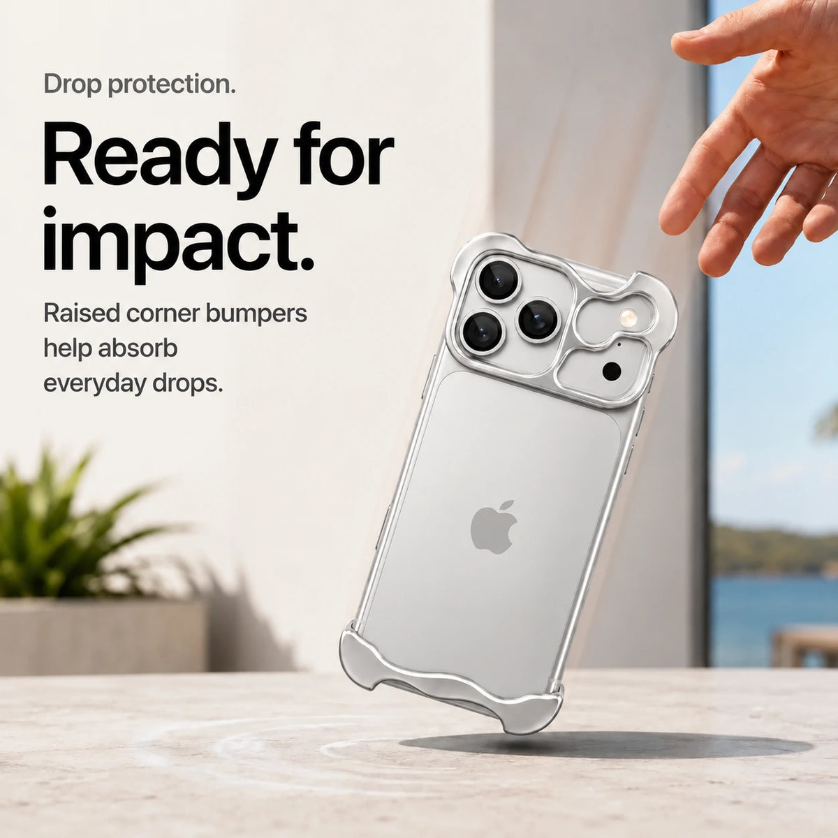 Silver sculpted metal phone case demonstrating raised corner protection during a drop #color_Titanium Silver