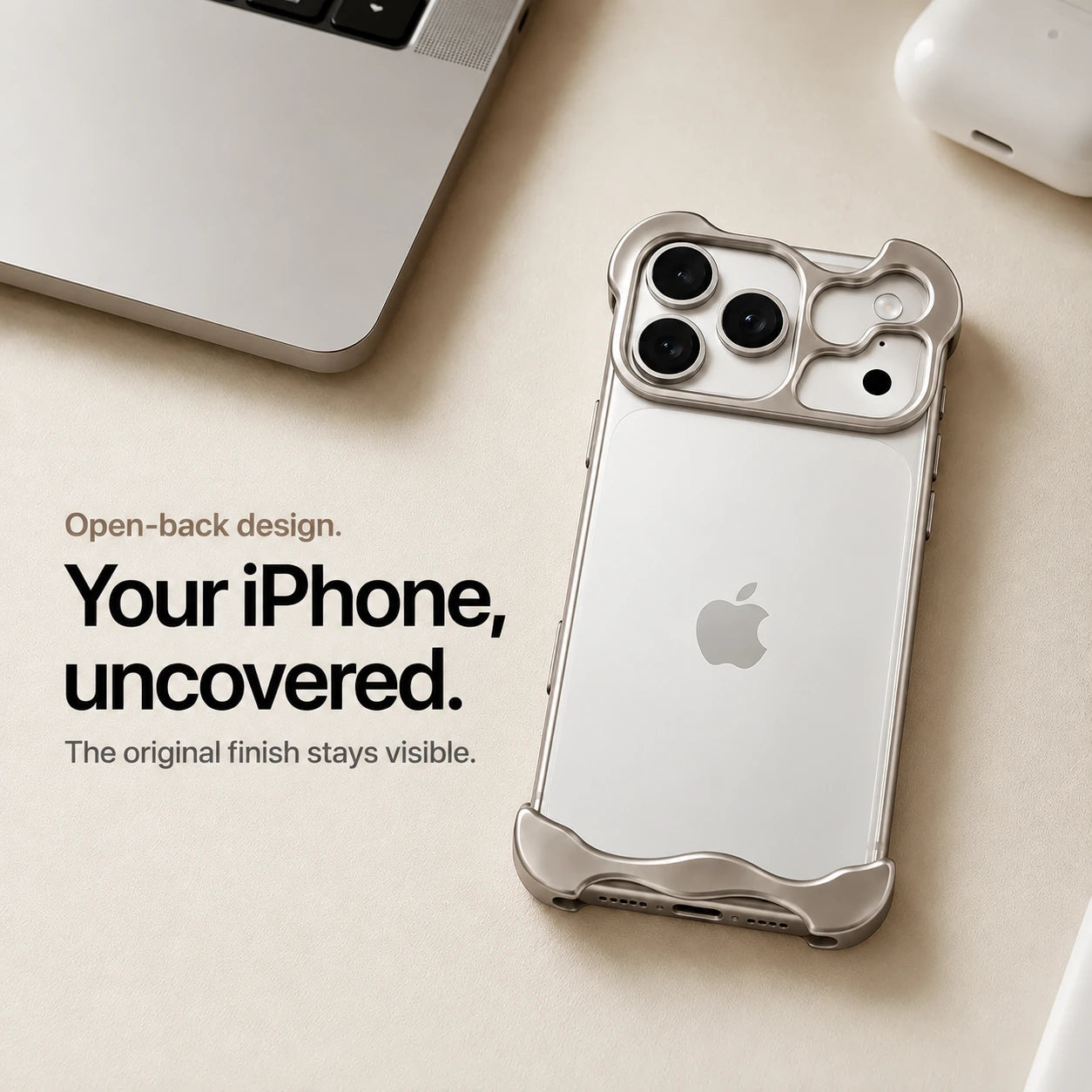 Warm gray sculpted metal phone case on a desk showing the open back #color_Natural Titanium