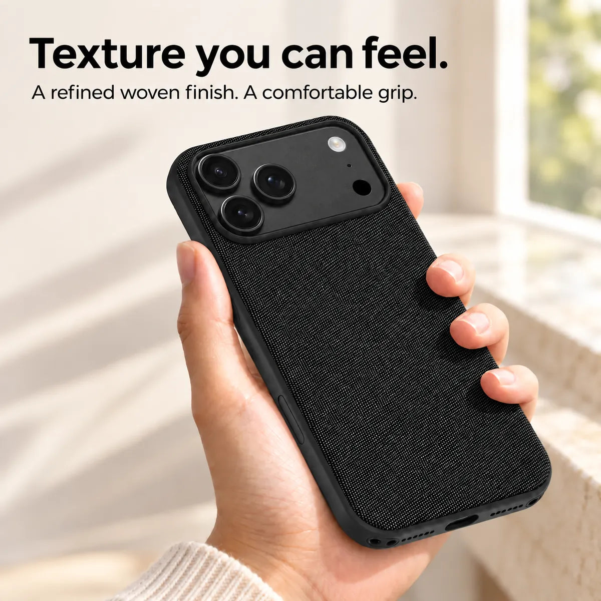 Hand holding a Midnight Black woven phone case, showing its textured fabric finish. #color_Midnight Black