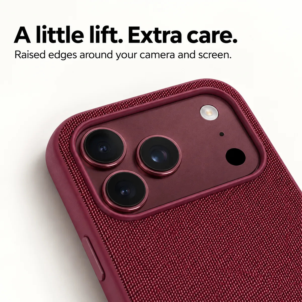 Close view of the raised camera surround and woven fabric on a Burgundy phone case. #color_Burgundy