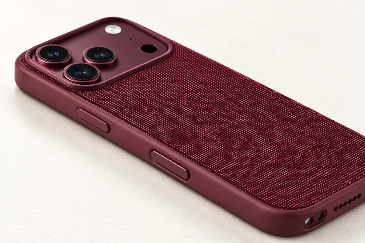 Close view of the Burgundy woven phone case with power button, Camera Control and lower openings.